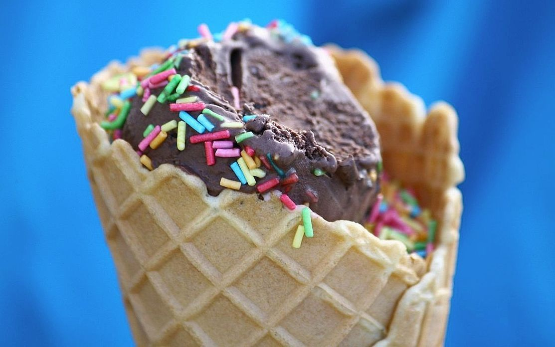 A generous scoop of dark chocolate gelato dusted with cocoa powder